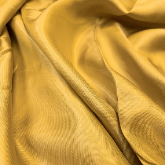 Подкладочная ткань нежно-золотистого цвета для пальтово-костюмной группы 436646 Италия 580 рублей за метр