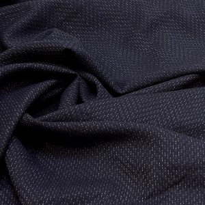 Костюмная шерсть из итальянского стока в тёмно-синем цвете с жаккардовой выработкой в ёлочку. Полотно мягкое, объёмное, воздушное. Хорошо тянется, просвечивает, сминаемость не высокая. Прекрасно подойдет для пошива изделий с мягким кроем: широкие брюки, юбка в мягкую складку, бомбер и платья свободного силуэта. Плотность 305 г/м. Отрез 2,7 м.